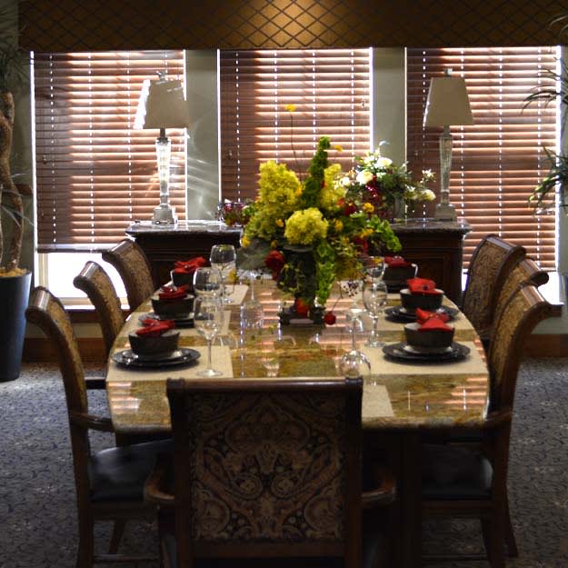 A beautifully set dining table with floral centerpieces and elegant decor.