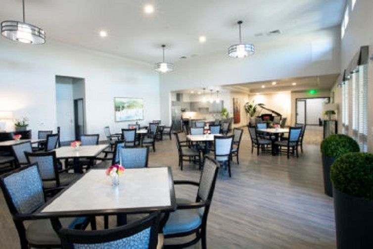 A modern dining area with neatly arranged tables and chairs.