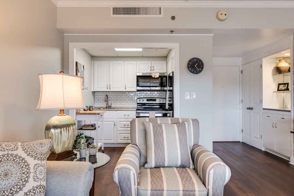 Cozy living room with a view into a compact kitchen area.