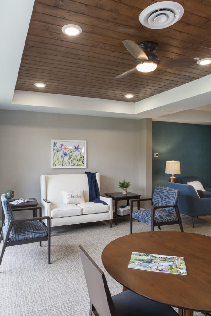 A modern living room with elegant furniture and a wooden ceiling.