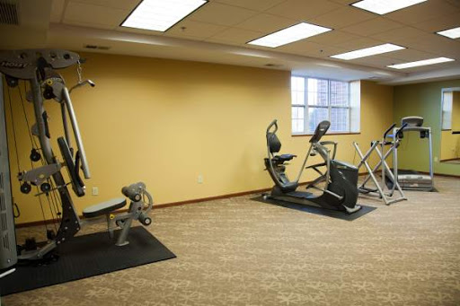 A well-equipped indoor gym featuring various exercise machines.