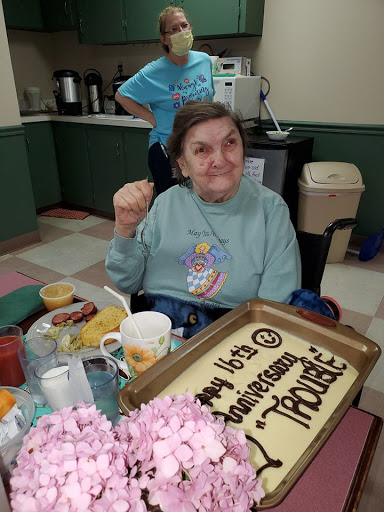 A joyful birthday celebration with cake and snacks, bringing smiles to the gathering.