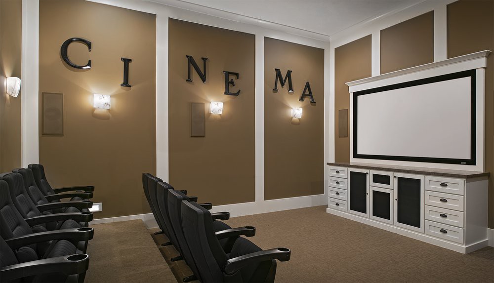 A cozy home theater setup with rows of seating and a large screen.