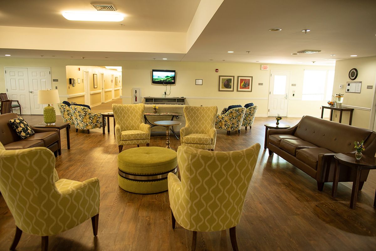 A modern living room with comfortable seating and a television on the wall.