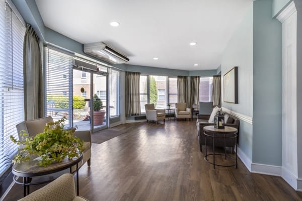A spacious lobby with comfortable seating and large windows allowing natural light to fill the room.