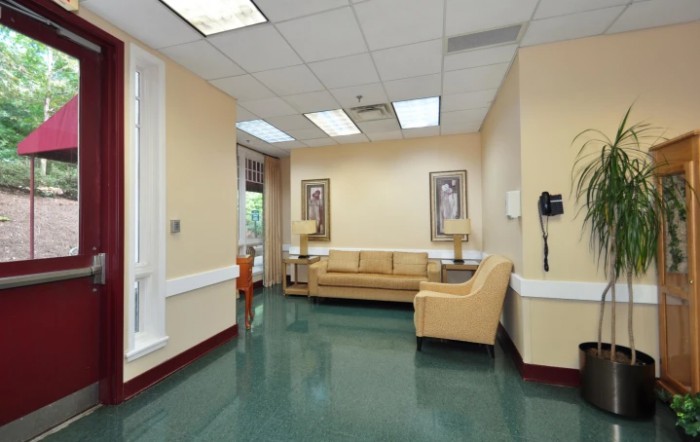 A well-lit waiting room with a sofa and decorative elements.