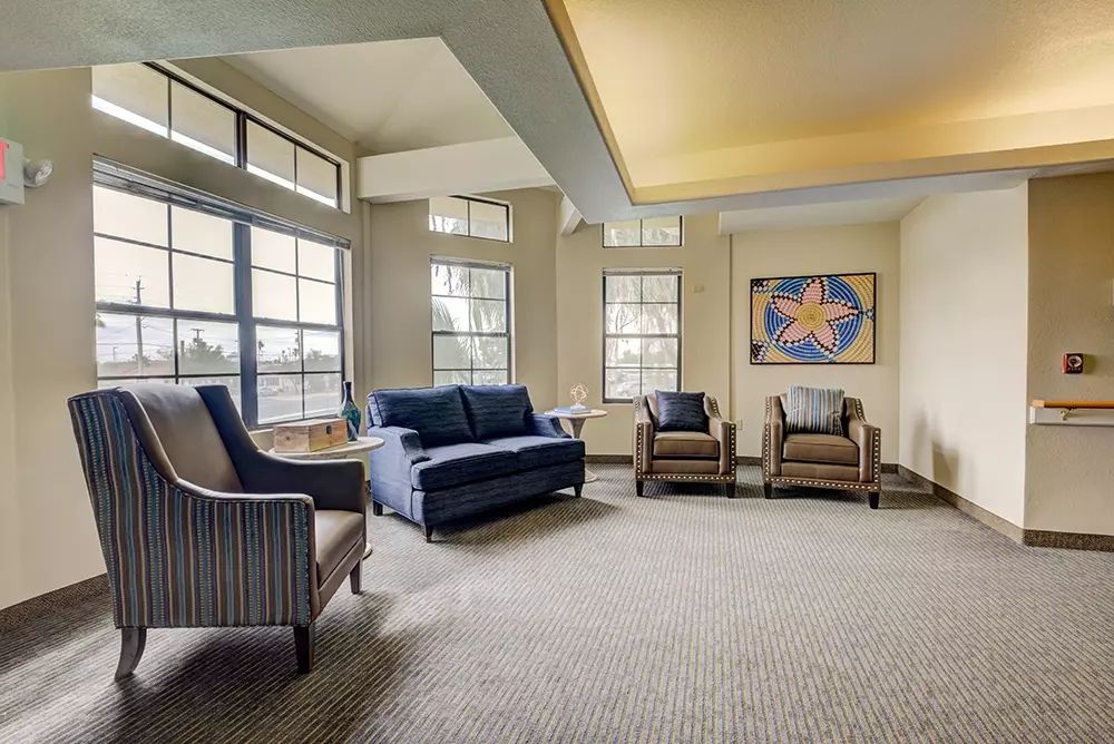 A modern living room with elegant furnishings and artwork.