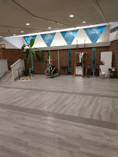 A spacious and modern indoor lobby featuring decorative elements and greenery.
