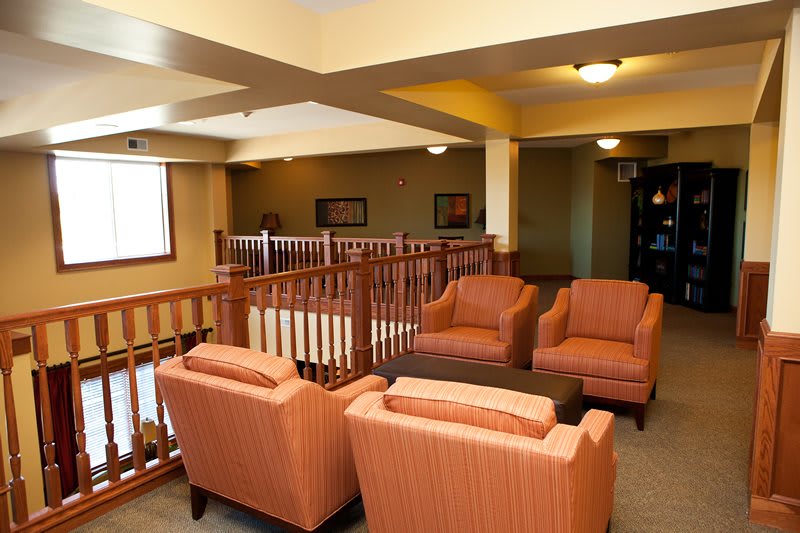 A cozy lounge area with comfortable seating arrangements and warm lighting.