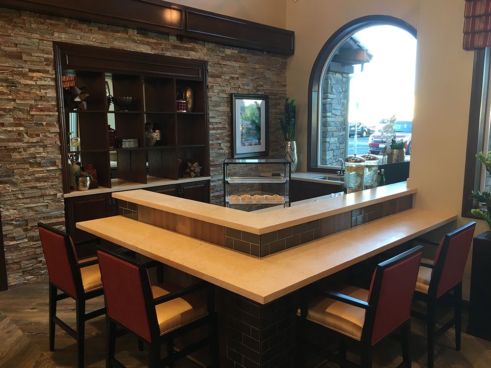 A modern bar area with a stylish countertop and seating in a restaurant setting.