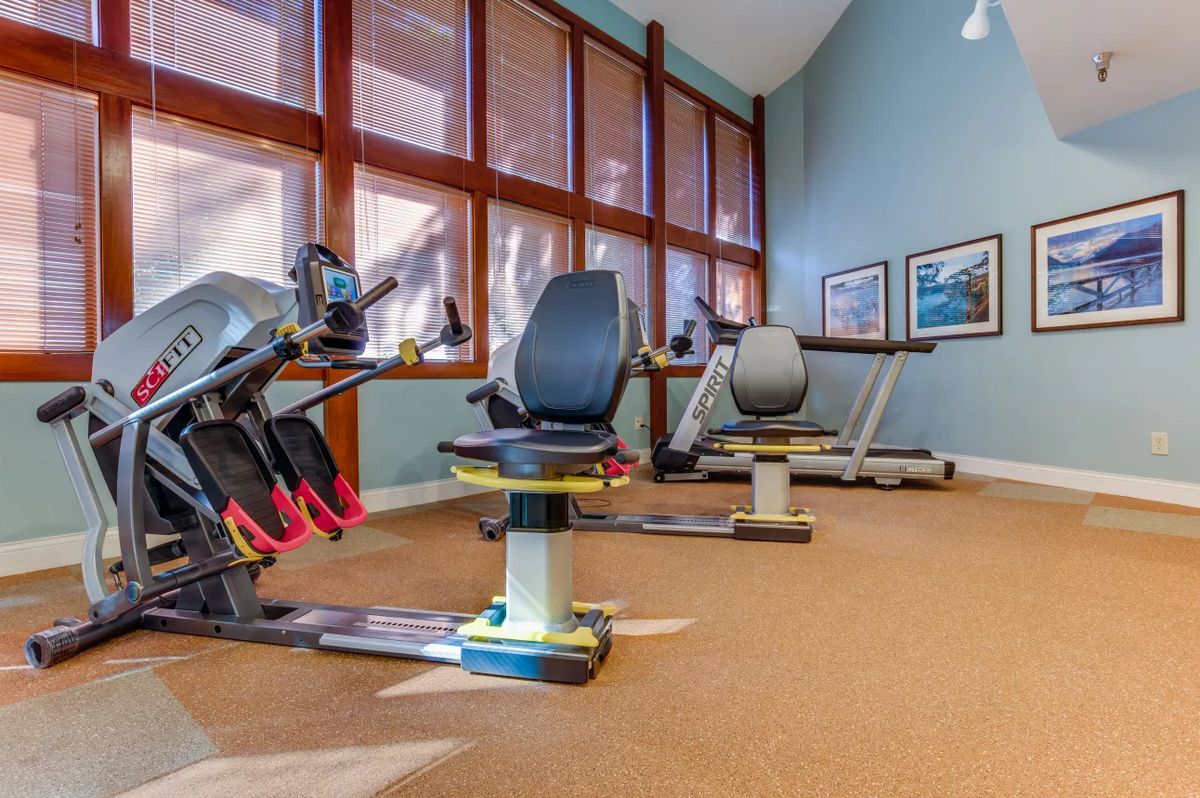 A bright and spacious gym with stationary bikes and a treadmill, perfect for indoor workouts.