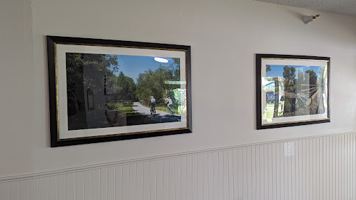 Two framed landscape photographs hanging on a wall.