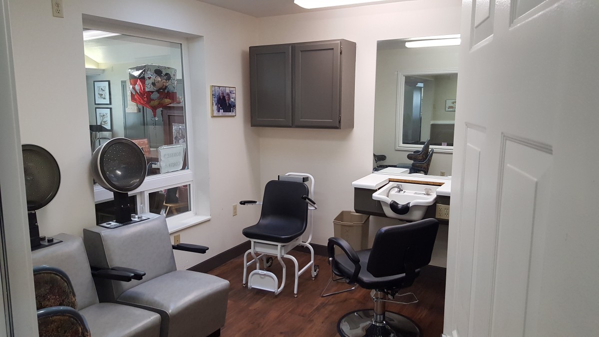 A well-equipped salon interior with chairs and mirrors.