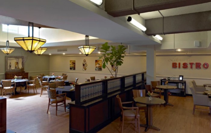 A cozy restaurant dining area with tables and chairs arranged for patrons.