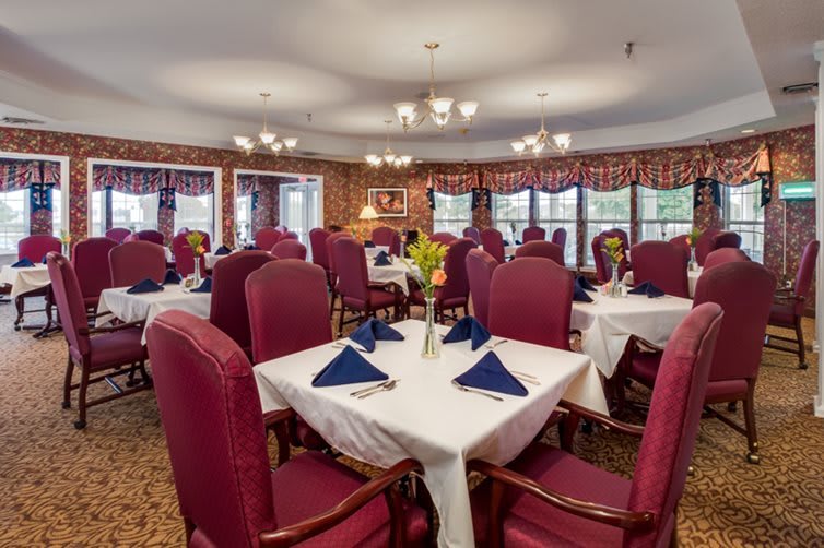 An elegant dining room with neatly arranged tables and chairs.