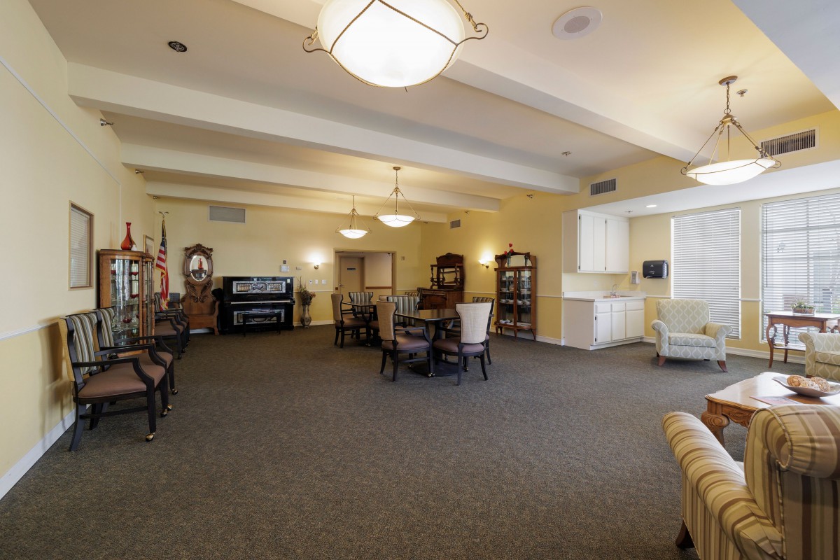 A well-lit meeting room with tables, chairs, and decorative furnishings.