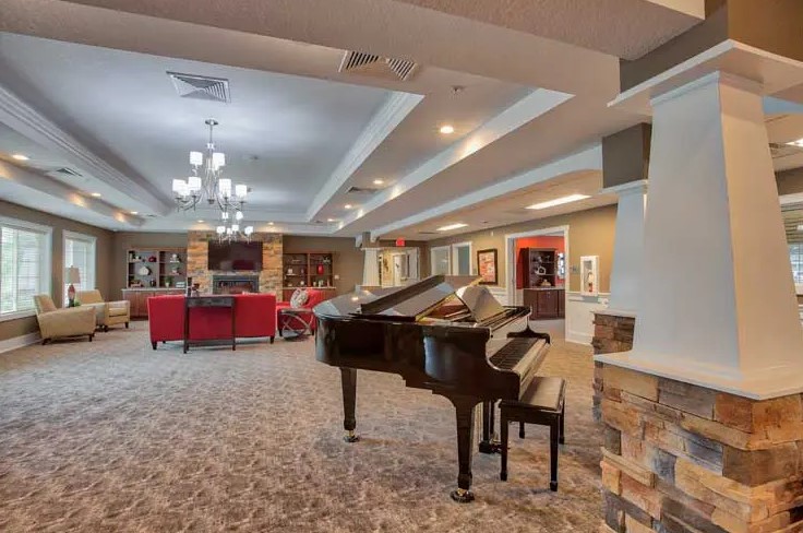 A spacious lounge area with a grand piano and comfortable seating arrangements.