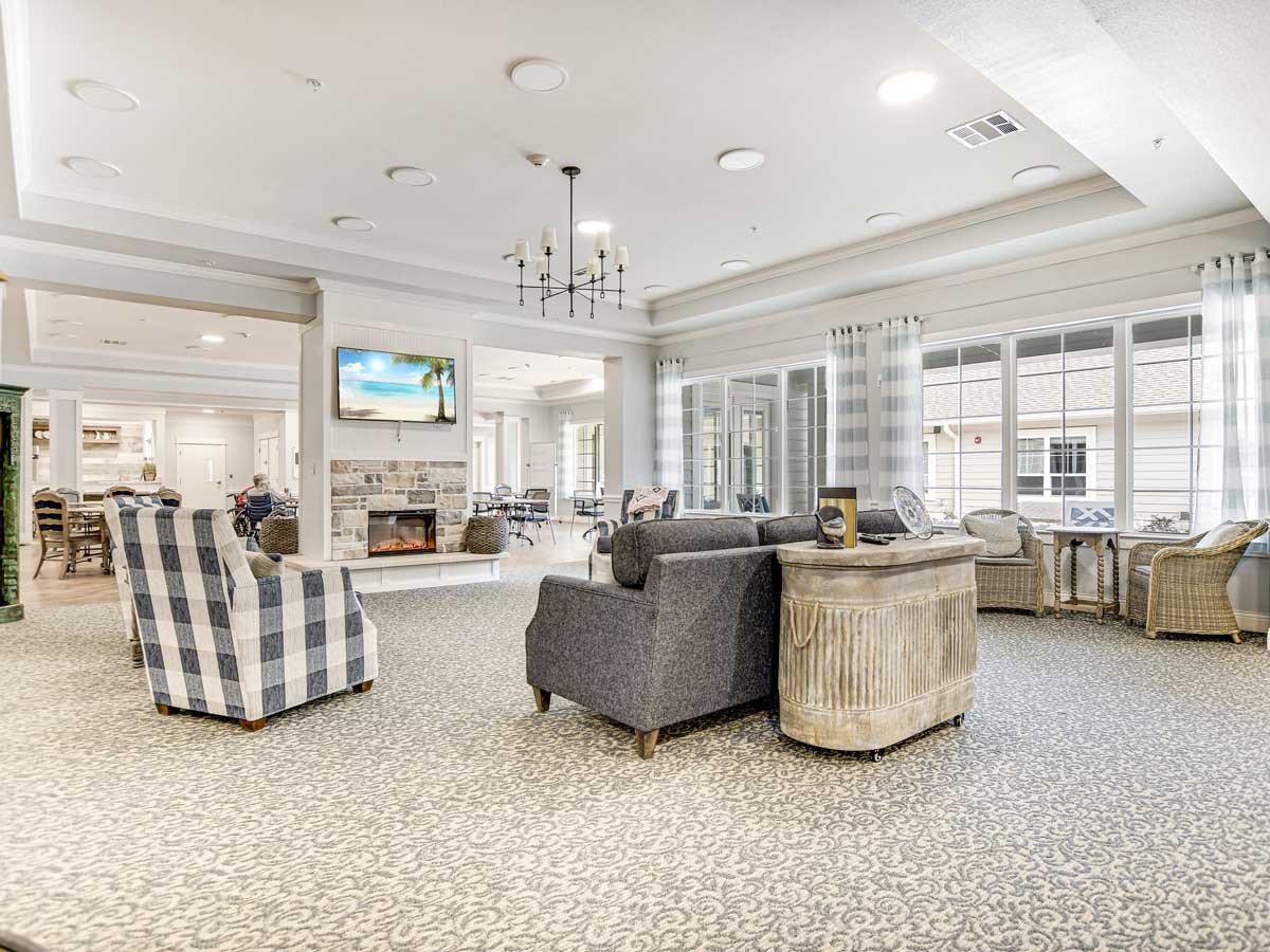 A spacious and well-lit living room with modern furniture and decor.