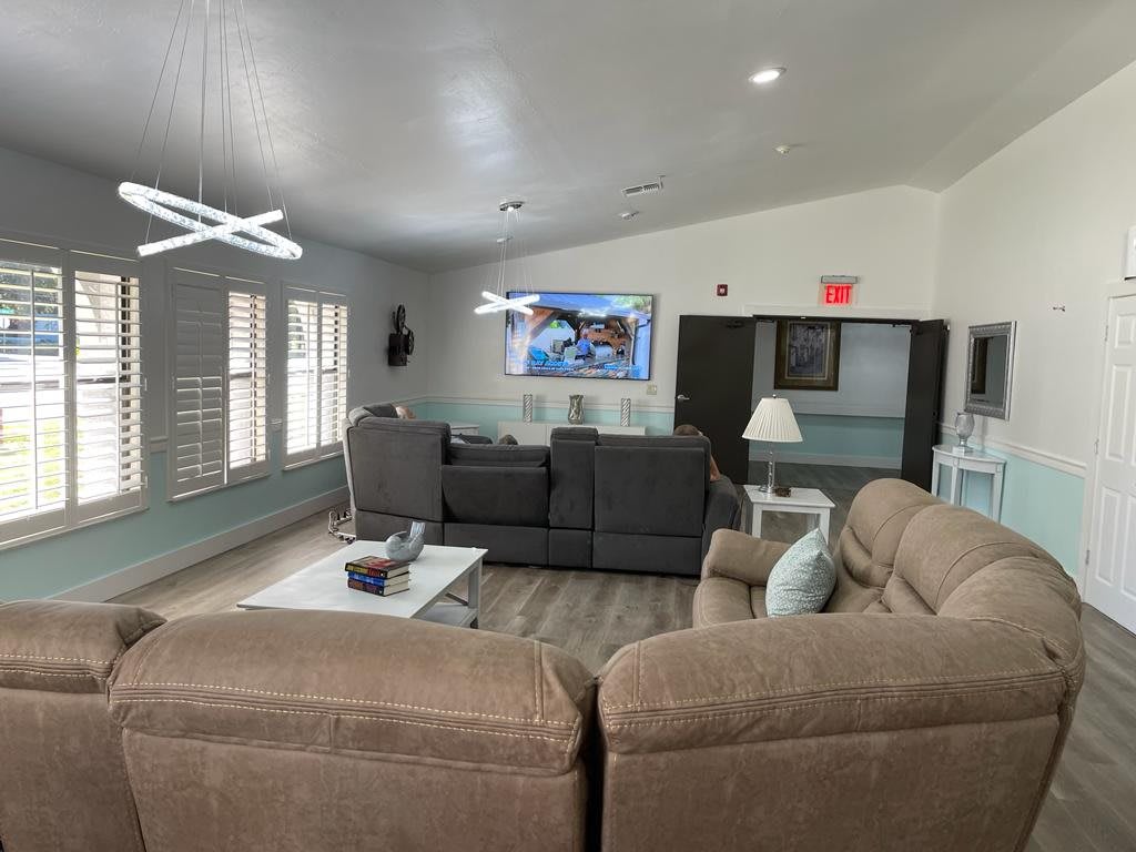 A modern living room with comfortable sofas and a mounted television.
