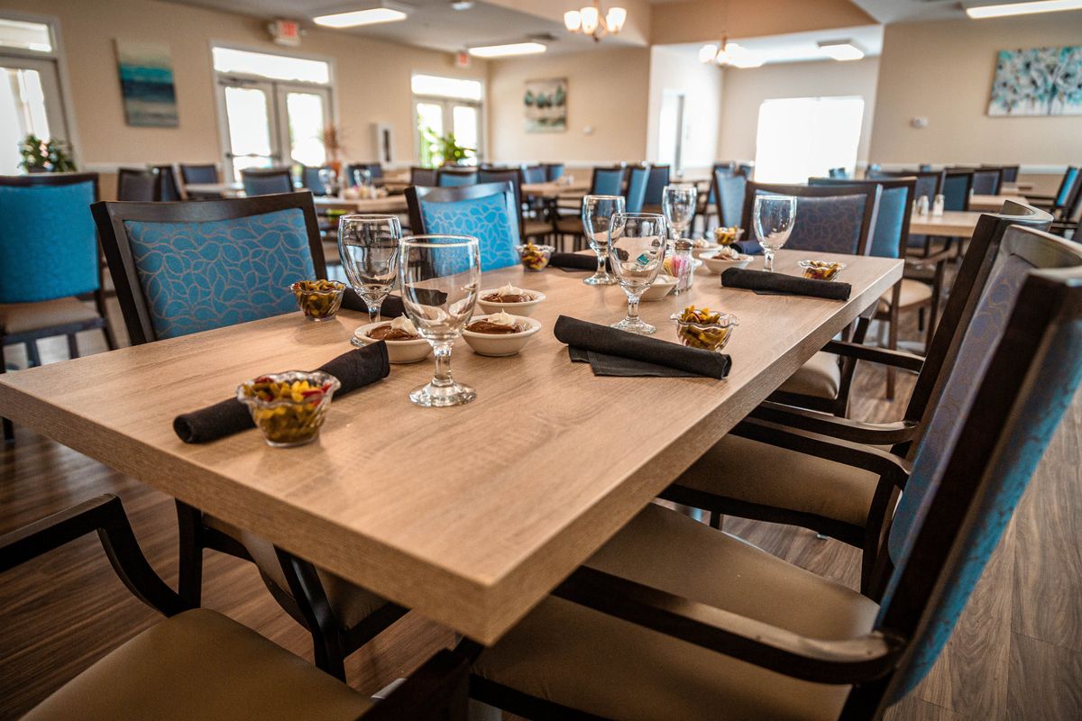 A well-set dining table in a restaurant with elegant glassware and cutlery.