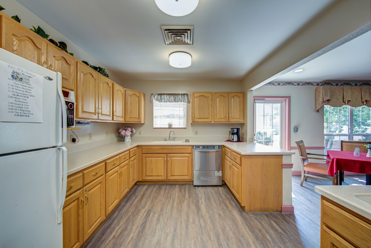 A spacious kitchen with wooden cabinets and modern appliances.