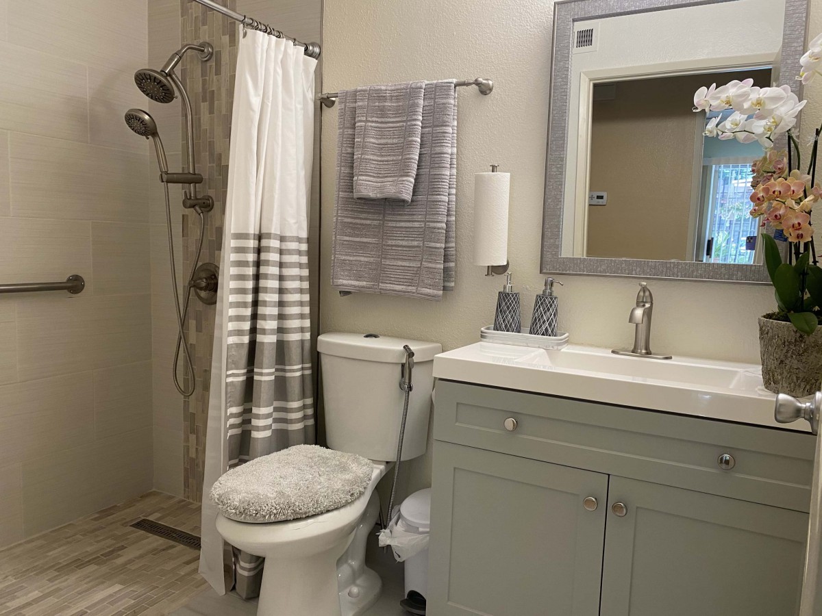 A neatly arranged bathroom with a shower, toilet, and vanity.