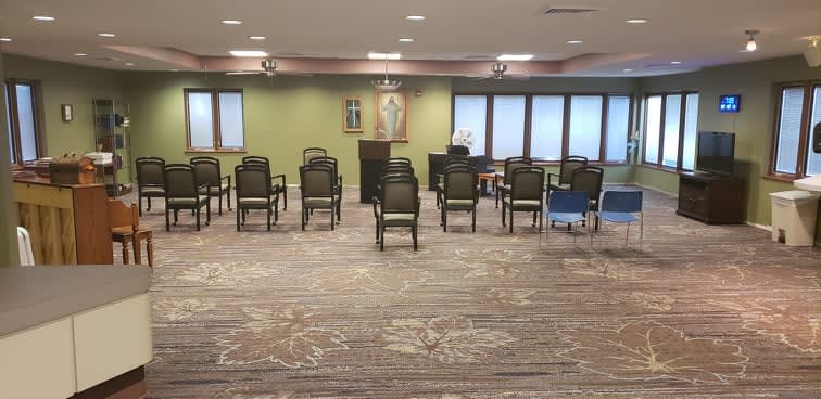 A room arranged with chairs facing a podium, suitable for meetings or gatherings.