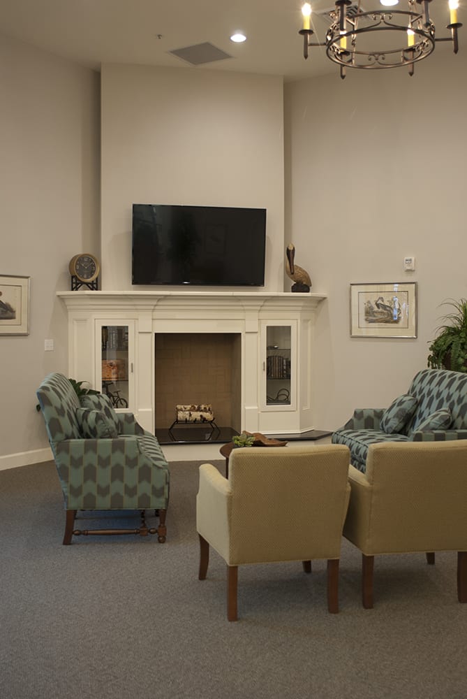 A cozy living room featuring a fireplace, television, and comfortable seating.