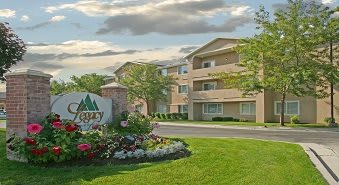 A suburban apartment complex with well-maintained landscaping.