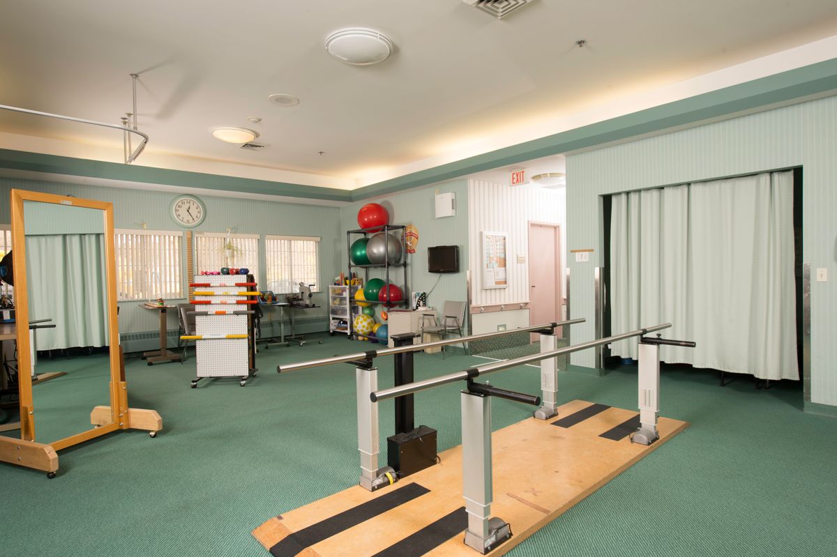 A well-equipped physical therapy room with various rehabilitation tools and exercise equipment.