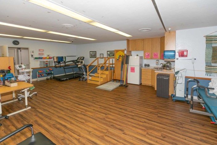 A well-equipped physical therapy room with exercise equipment and tools.