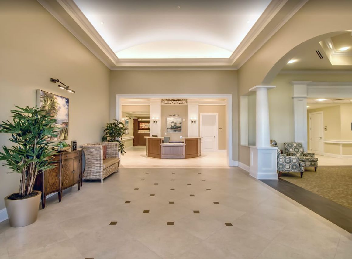 A spacious and elegantly designed lobby with decorative furniture and soft lighting.