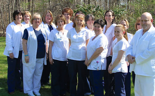 A group of dedicated healthcare professionals posing together in an outdoor setting.