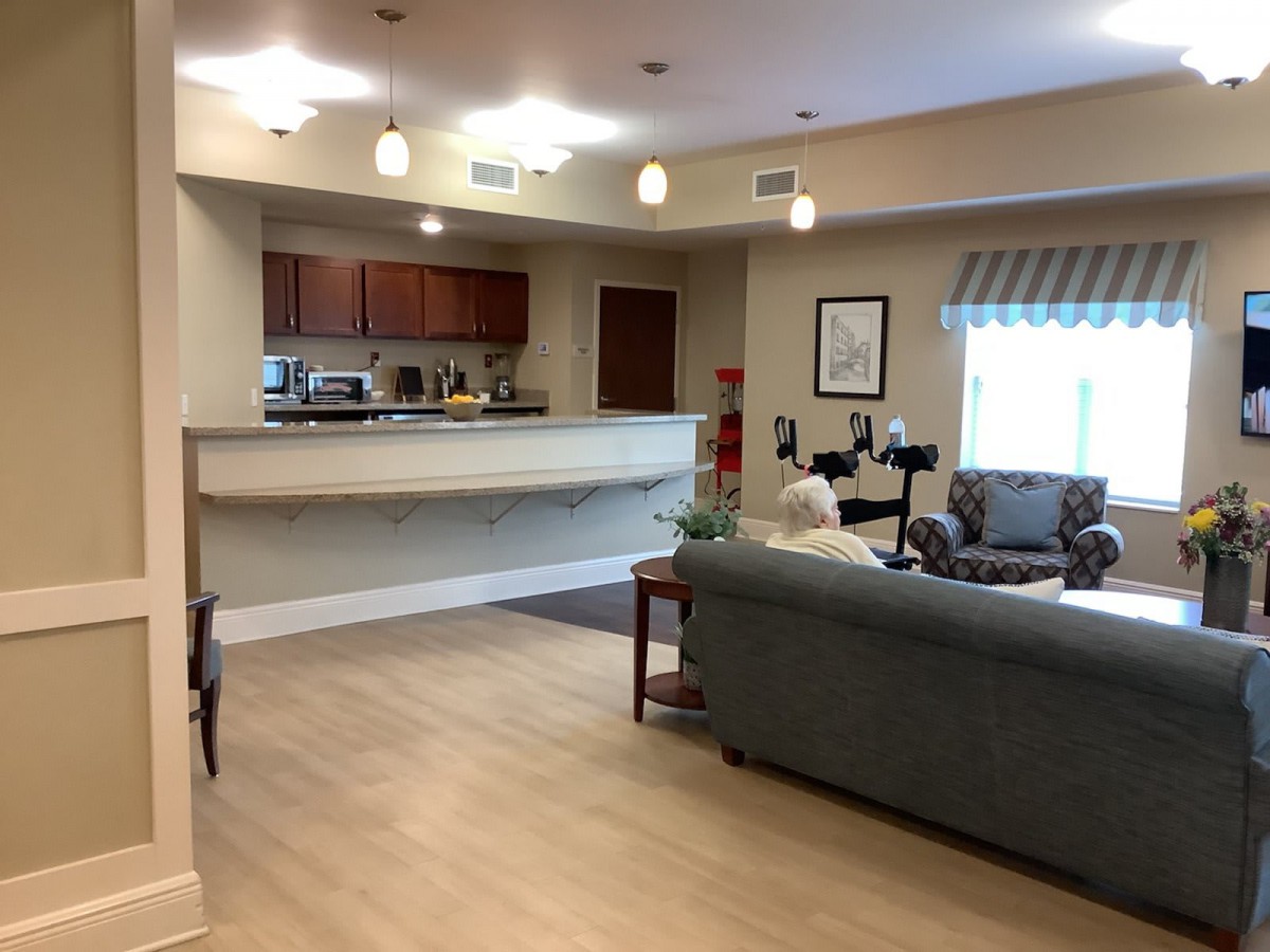 A modern living area with an open kitchen and comfortable furniture.