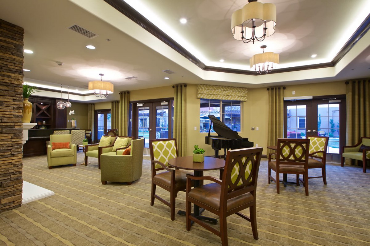 A stylish and comfortable living room with a piano and elegant furniture.