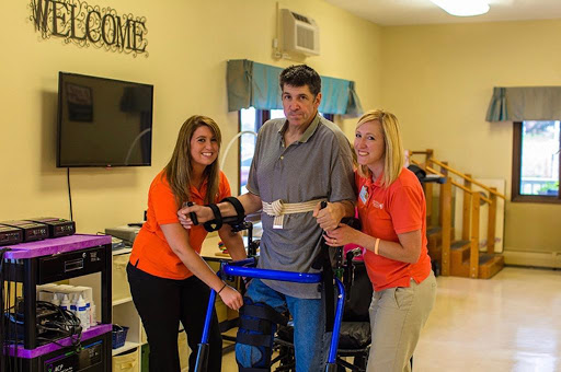 A moment of progress in rehabilitation, showcasing the support from dedicated staff.