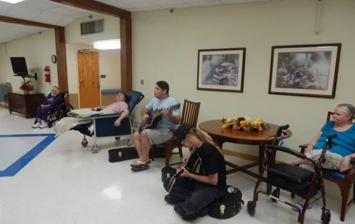 Musicians performing at a nursing home for residents.