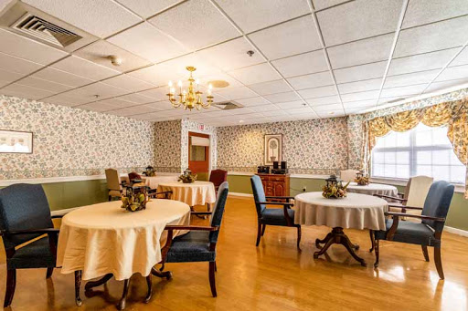 A cozy dining area featuring tables with tablecloths, elegant chairs, and decorative elements.
