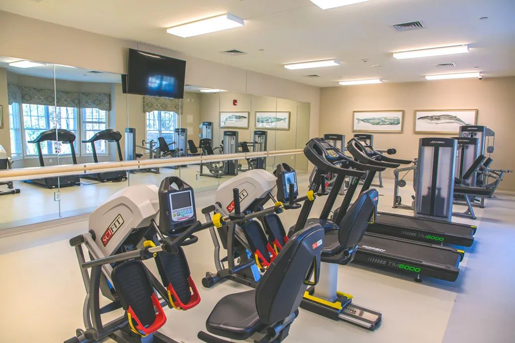 A well-equipped gym with treadmills and stationary bikes for exercise.