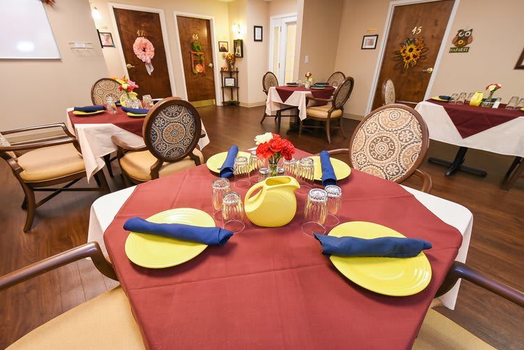 A neatly set dining table in a cozy restaurant interior.