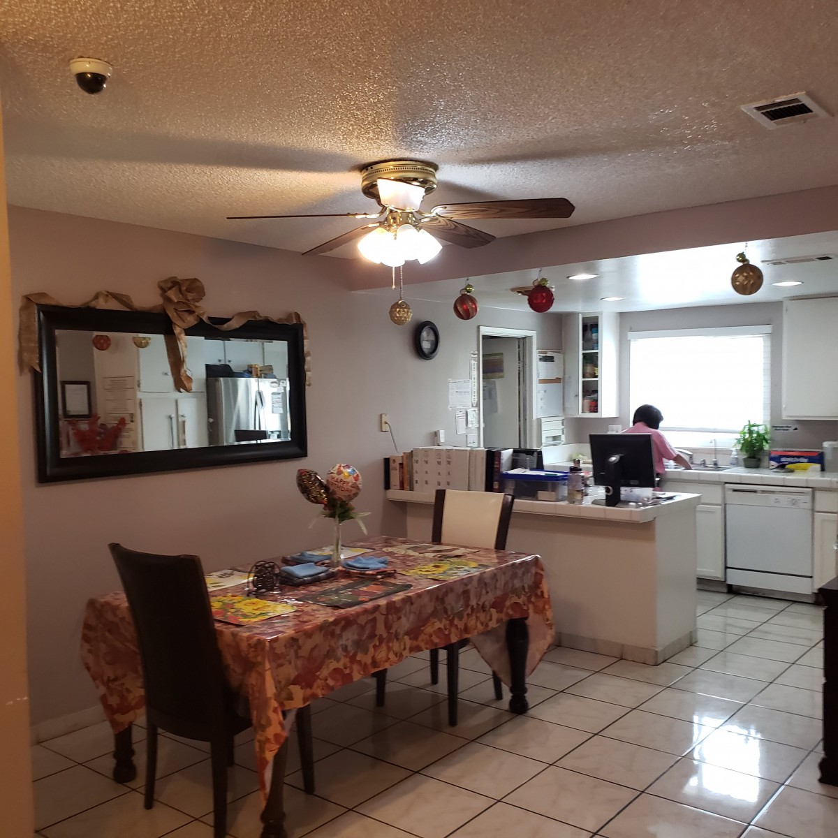 A cozy dining area with a table and chairs, connected to a kitchen.