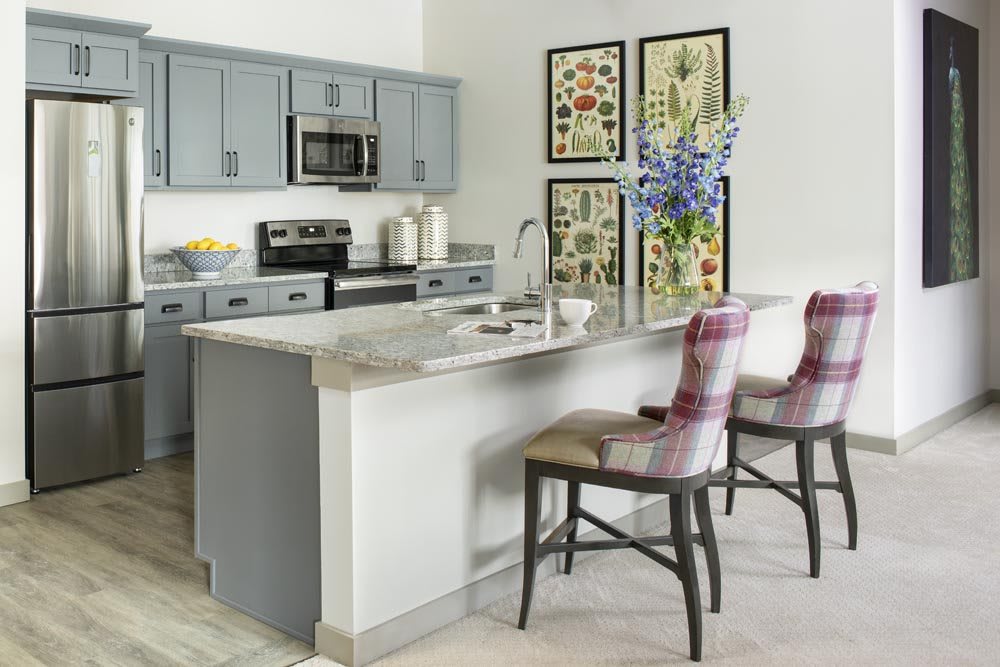 Modern kitchen with an island and stylish decor.