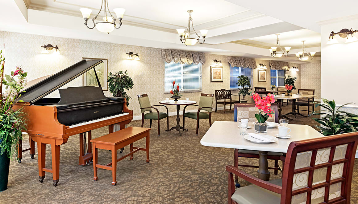 A cozy dining area with a piano and elegant decor.
