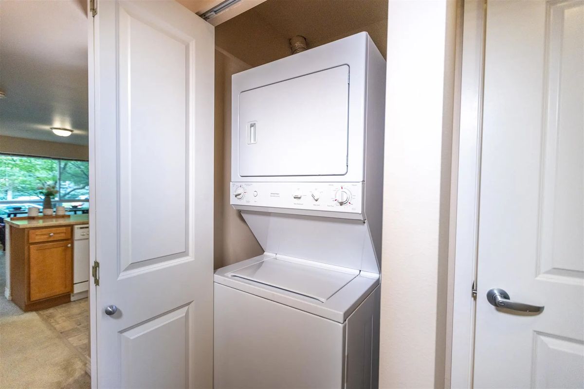 A stacked washer and dryer unit in a small closet space.