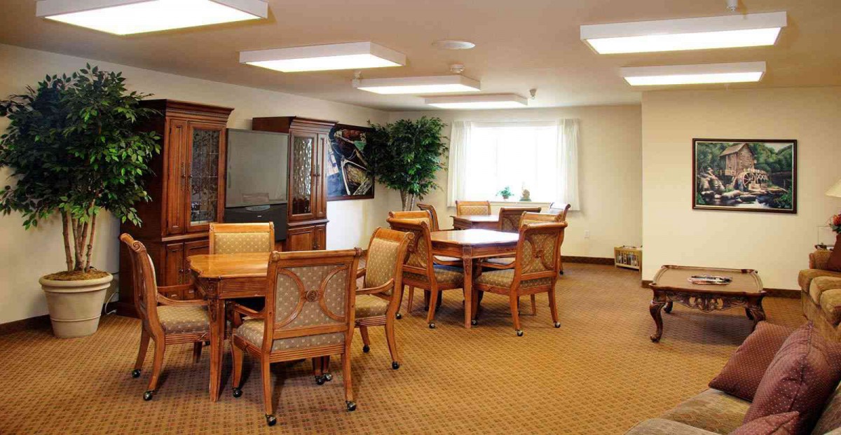 A well-furnished meeting room with wooden tables and chairs.