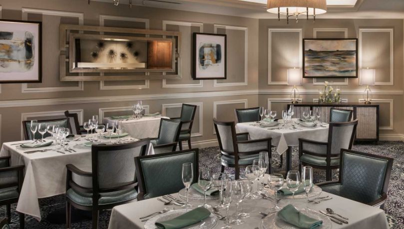 Elegant restaurant dining room with neatly arranged tables and stylish decor.
