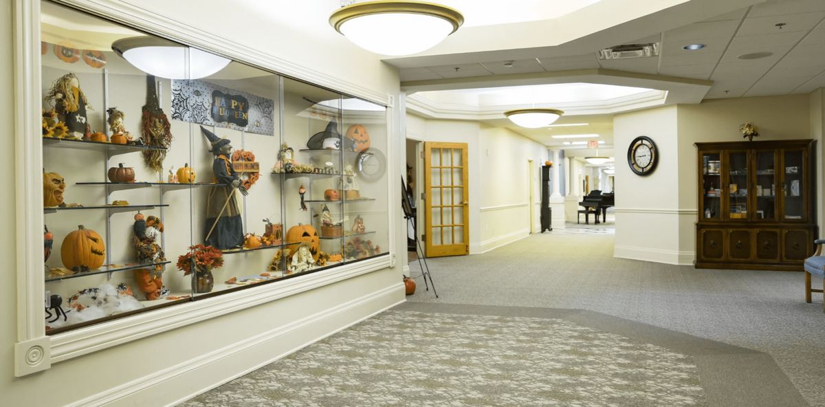 A hallway with a museum display case showcasing various artifacts.