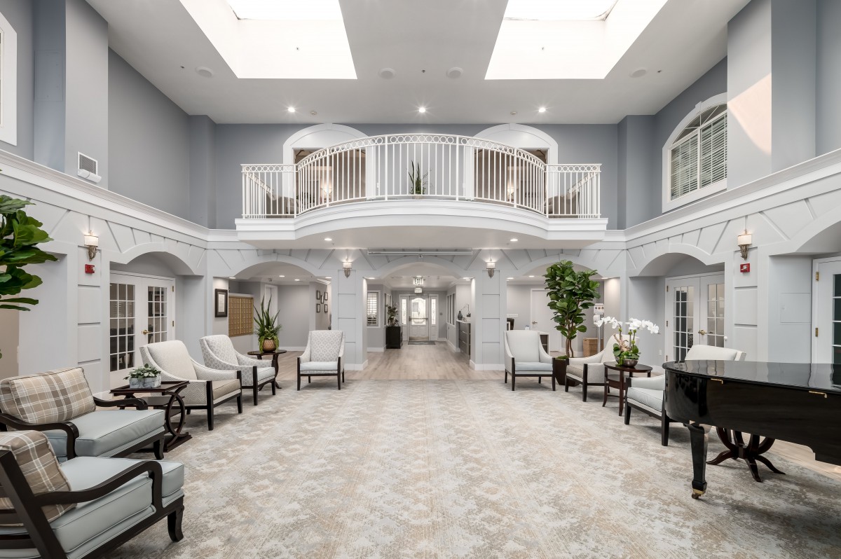 A spacious and elegantly designed lobby featuring comfortable seating and a bright, airy atmosphere.