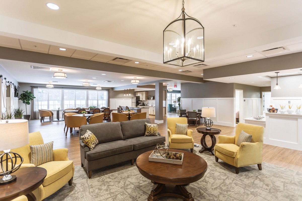 A spacious and well-lit living area with modern furniture and a cozy atmosphere.
