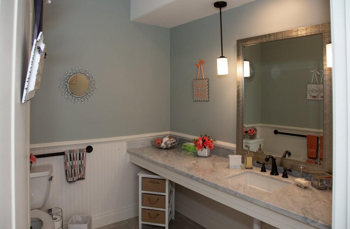 A well-organized bathroom with a modern vanity and ambient lighting.